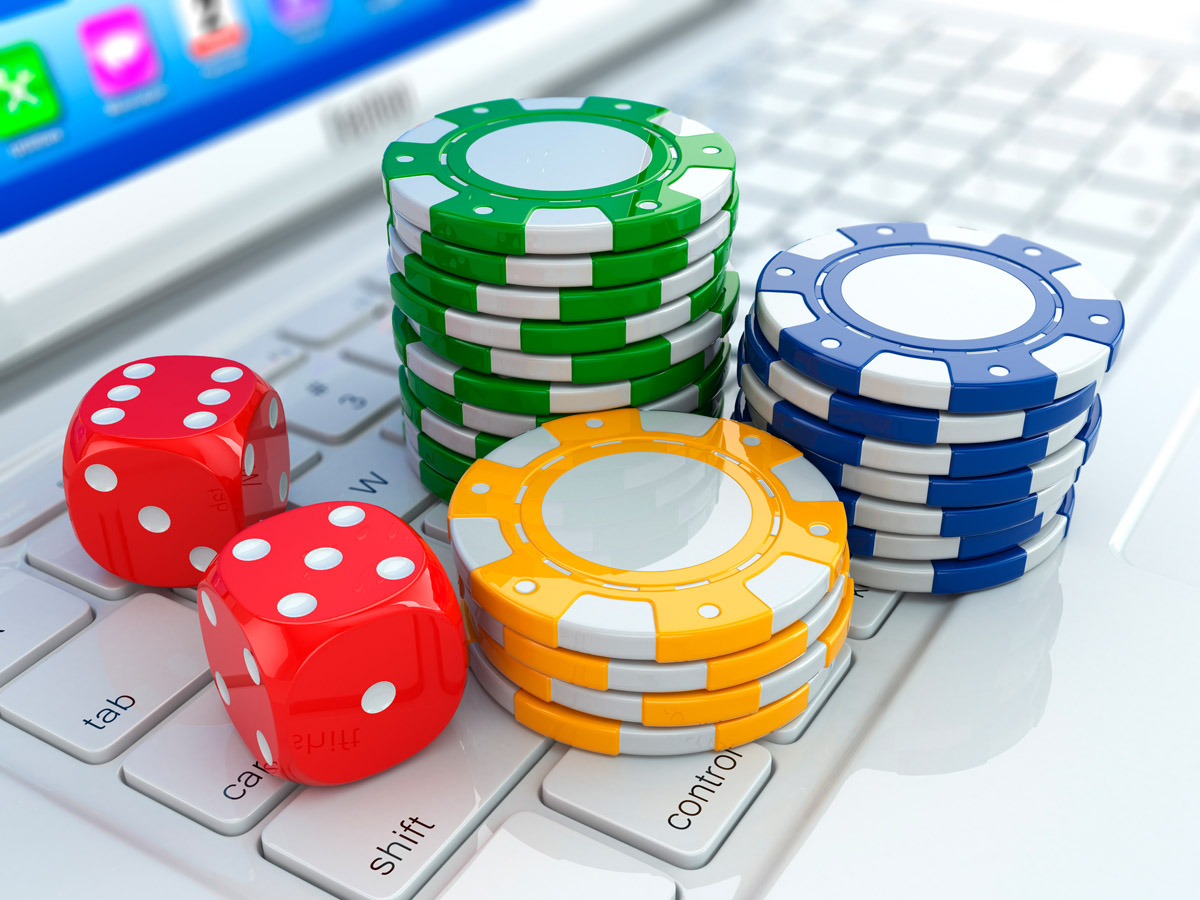 Online casino. Dices and chips on laptop.